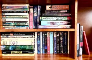 Emily's photo of her bookcase shows her copies of all the Diana Wynne Jones books to be read in the readthrough. Many are tattered.