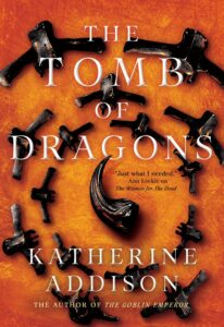 the cover of the tomb of dragons by Katherine Addison has a spiral of black claws or bones against a fire orange background